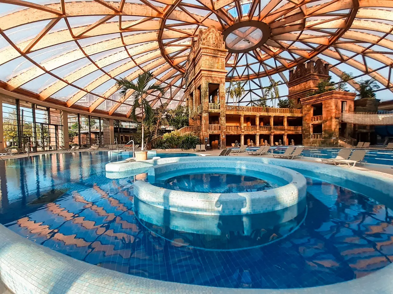 The glass-domed indoor pool hall at Aquaworld Resort Budapest with its turreted centrepiece