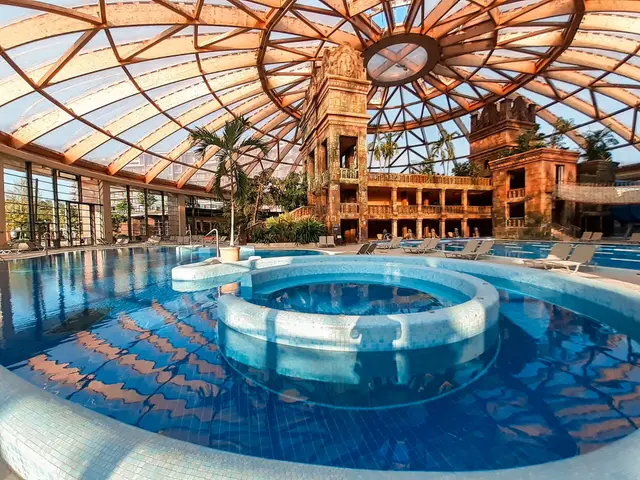 The glass-domed indoor pool hall at Aquaworld Resort Budapest with its turreted centrepiece