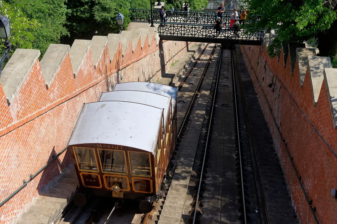 A vintage wooden funicular car on the steep tracks of the Buda Castle Hill Funicular