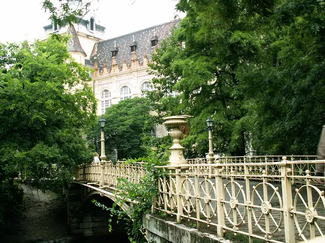A bridge and iron railings beside Vajdahunyad Castle in Városliget, Budapest's City Park