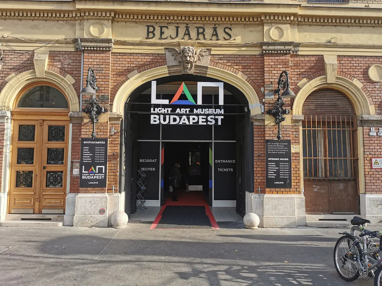 The brick entrance arch of the Light Art Museum (LAM) with its illuminated sign