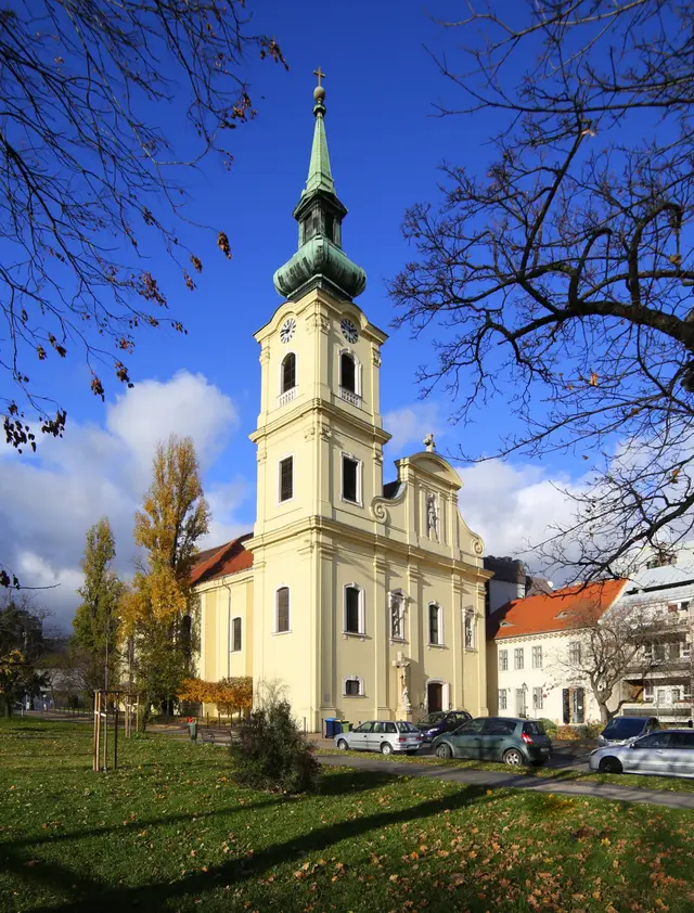 The yellow Baroque Tabán parish church of St Catherine with its clock tower