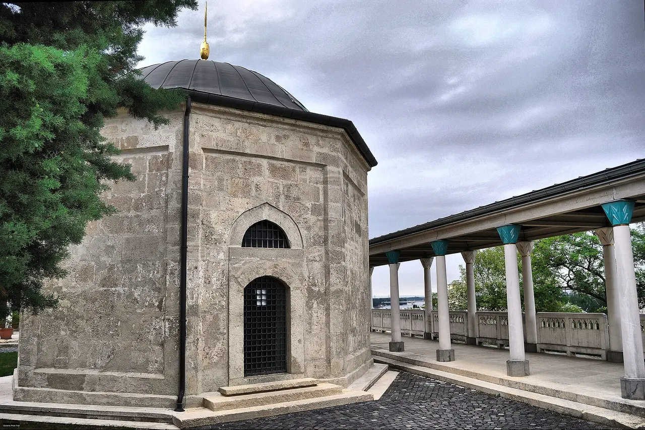 The octagonal stone tomb of Gül Baba with its dome and a colonnade beside it