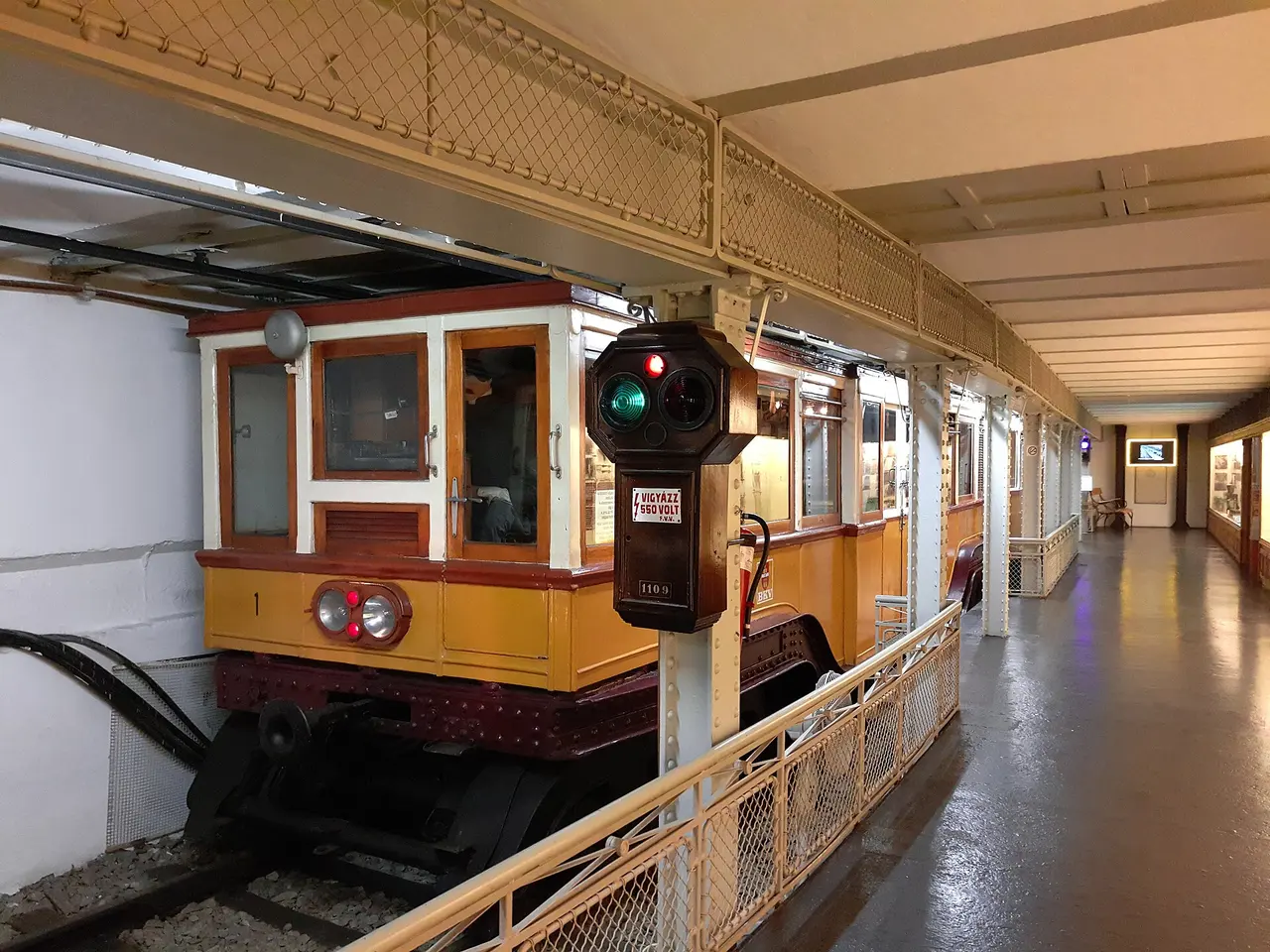A vintage yellow metro carriage on display in the Underground Railway Museum
