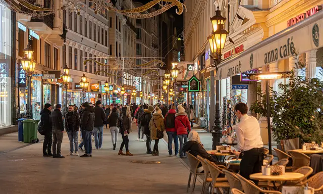 Crowds and café terraces on pedestrian Váci Street in the evening